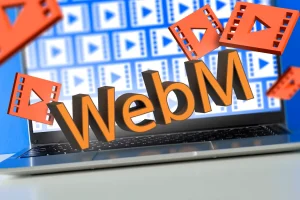 
یک لپ‌تاپ با چندین نماد فایل ویدیویی و یک «WebM» در بالای صفحه‌کلید و تعدادی نماد ویدیوی سه بعدی در اطراف.